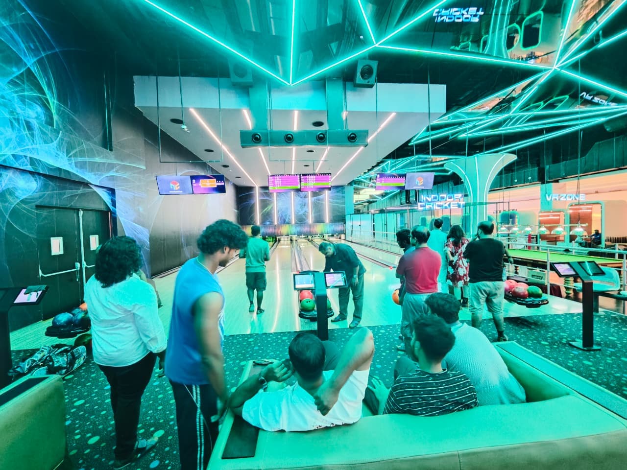 Men from ECC watching and cheering at the bowling lanes