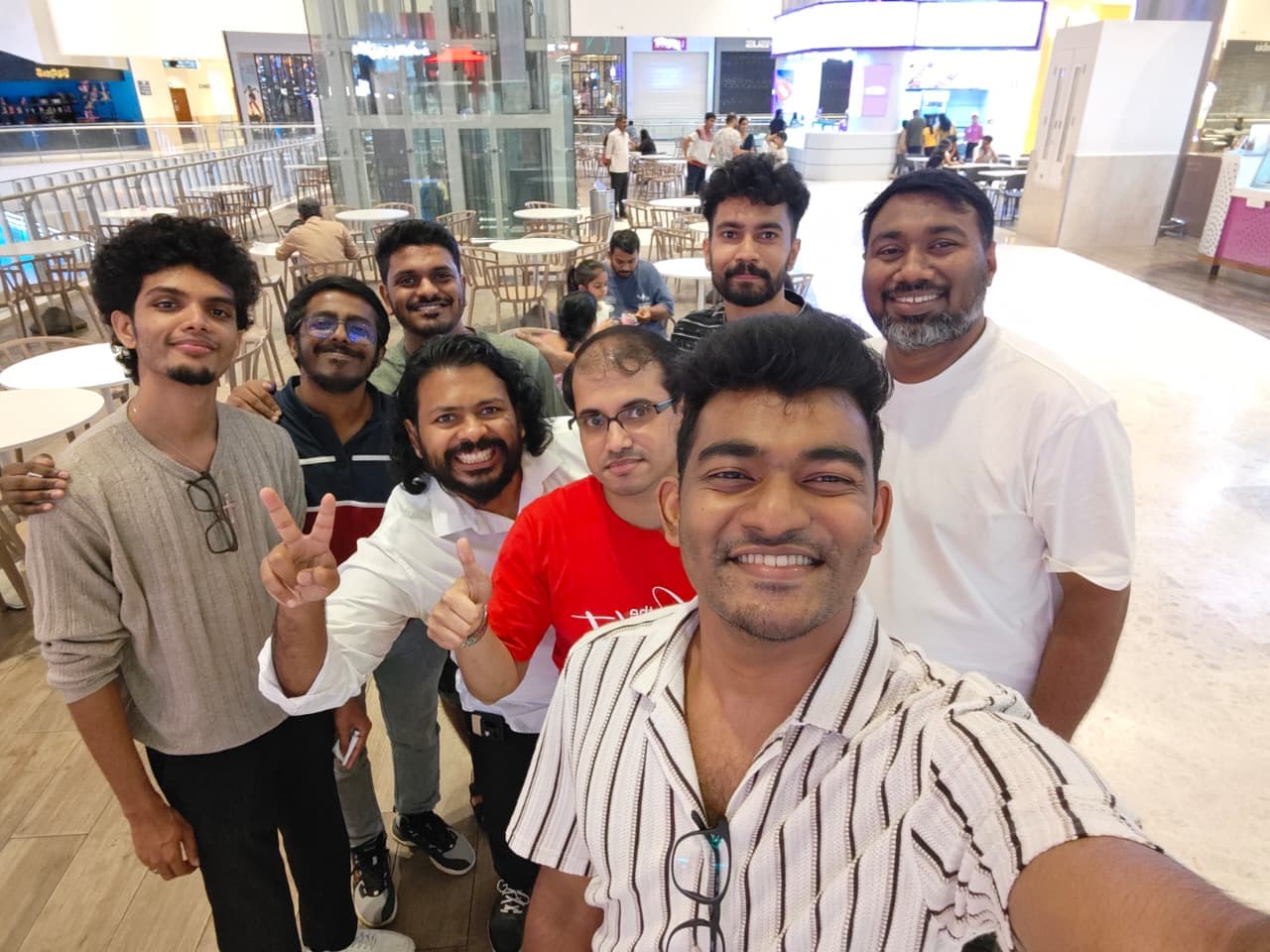 A group of men from ECC smiling in a selfie at a bowling night